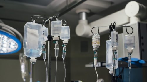 Intravenous drips in a hospital operating room, highlighting medical treatment and care.