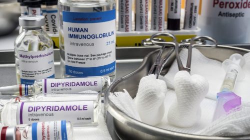 Intravenous medications and medical supplies arranged in a clinical setting, implying malpractice context.