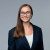 Smiling female lawyer in a professional suit, exuding confidence and approachability.