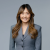 Professional headshot of a confident attorney in a gray suit, smiling.