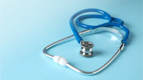 Stethoscope on light blue background representing medical negligence and malpractice cases.