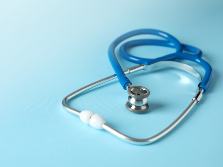 Stethoscope on light blue background representing medical negligence and malpractice cases.